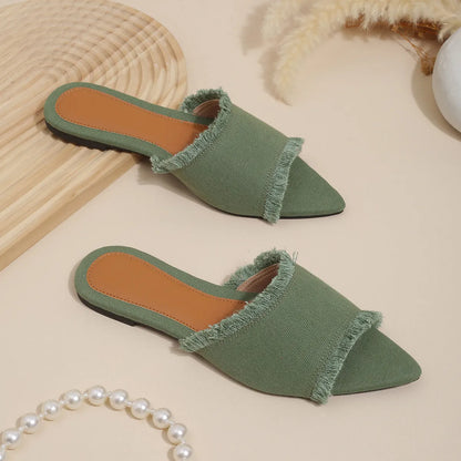 Women's denim flat slippers with tassel detail in apricot colour, showing leather lining.