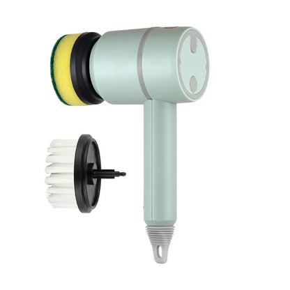 Green electric cleaning brush with multiple brush heads on a kitchen worktop.