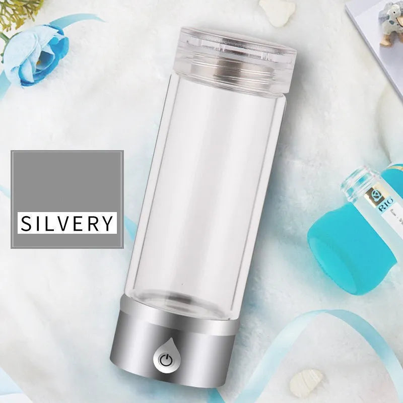 Portable hydrogen water ionizer bottle with high borosilicate glass cup in silver finish.