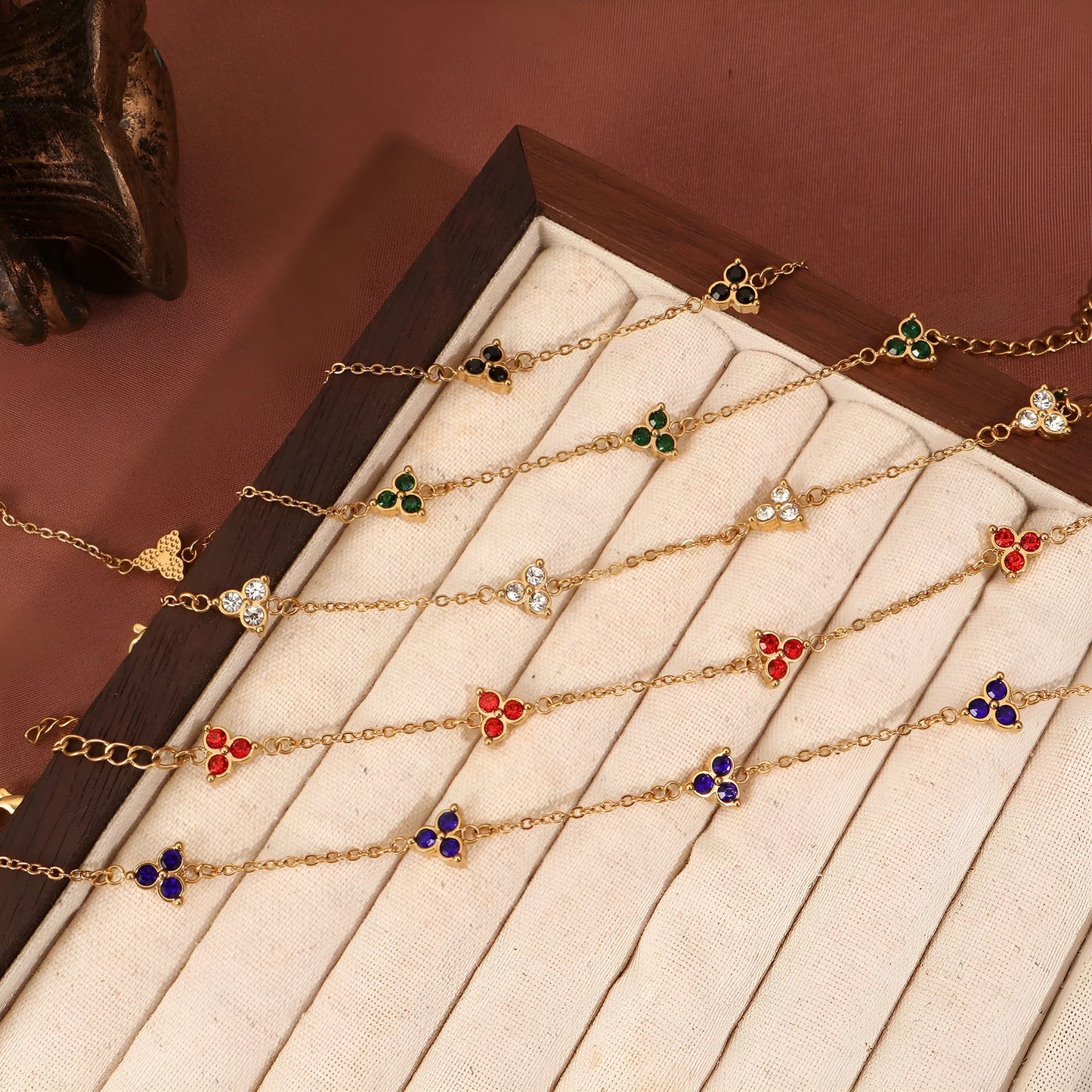 Women's stainless steel three diamond geometric triangular bracelet in gold finish with white zircon gemstones