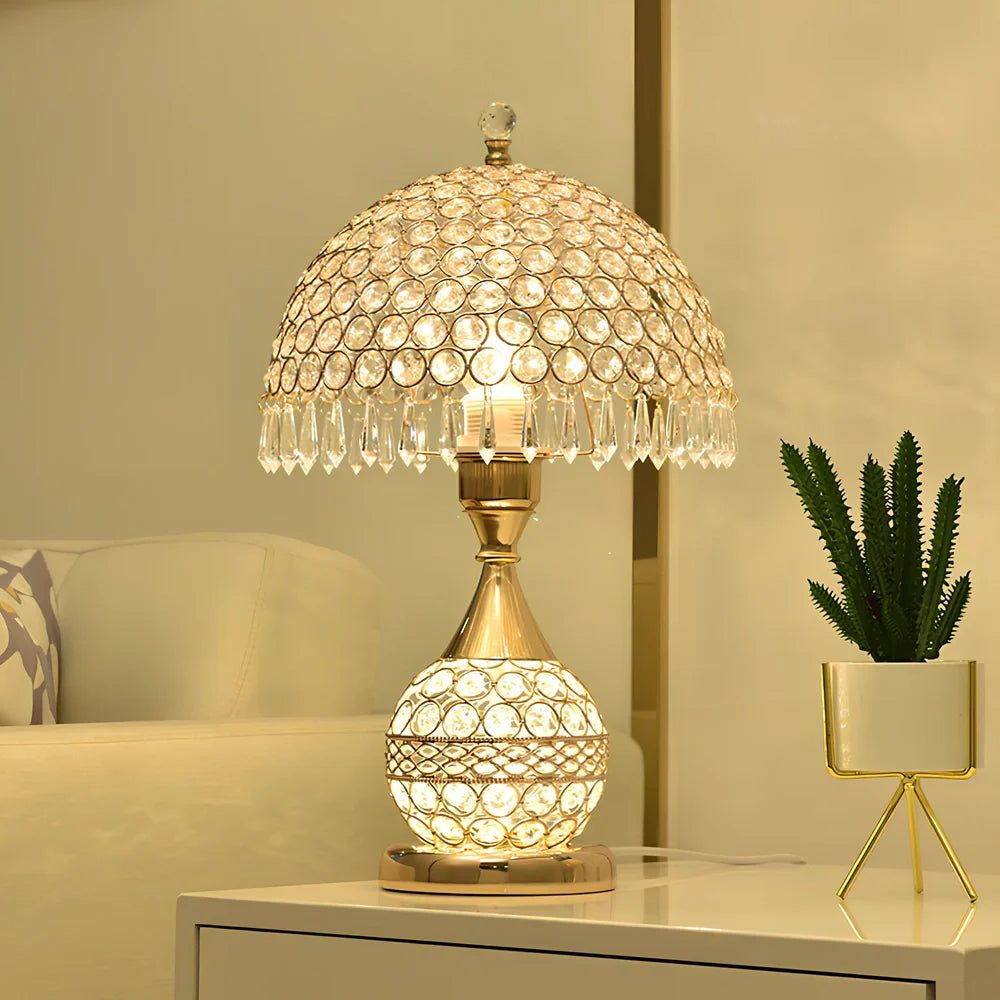 Gold crystal desk lamp with hand-cut facets and remote control on wooden surface