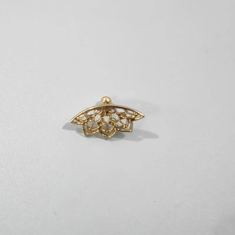 Close-up of a geometric spider web design on a gold-toned metal stud earring.