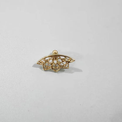 Close-up of a geometric spider web design on a gold-toned metal stud earring.
