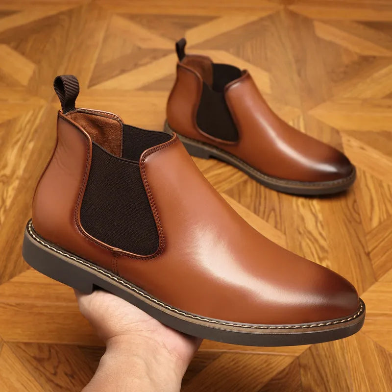 A pair of formal black leather pointed-toe boots with a square heel and rubber sole