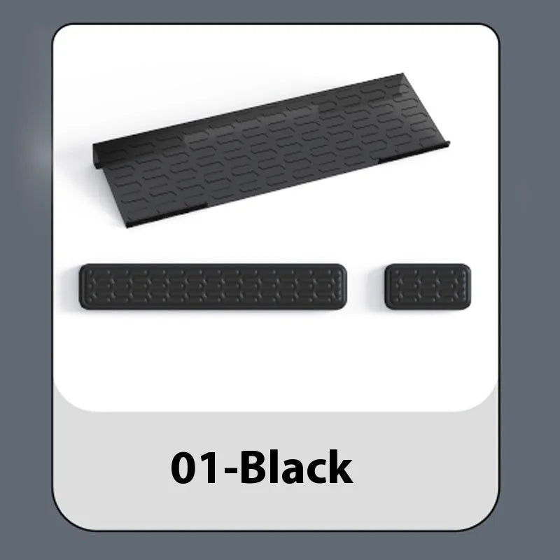 Double-sided black and grey keyboard mouse pad with wrist strap and hand pillow on a desk.