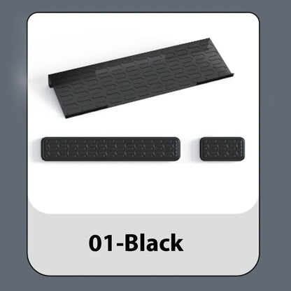 Double-sided black and grey keyboard mouse pad with wrist strap and hand pillow on a desk.