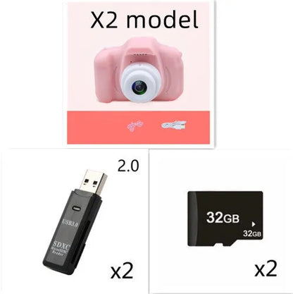 X2 HD mini digital camera for kids in silicone case with lanyard, shown capturing photo on 2-inch screen.