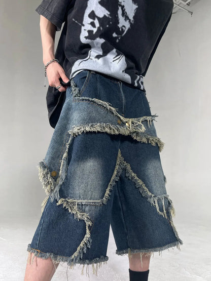 Blue men's denim shorts with frayed hem, loose fit, and a white five-pointed star patch on the leg.