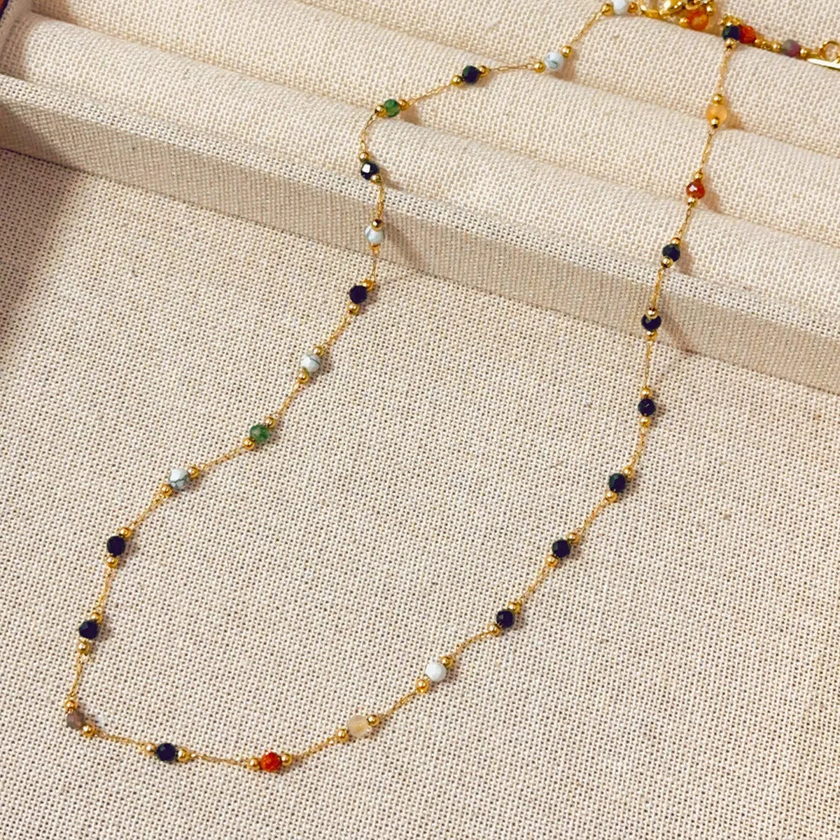 Gold electroplated titanium steel necklace for women with a natural stone pendant on an O-ring chain.