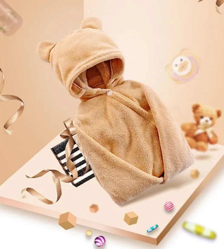 Blue hooded baby bath towel with dimensions 65cm by 110cm laid flat.