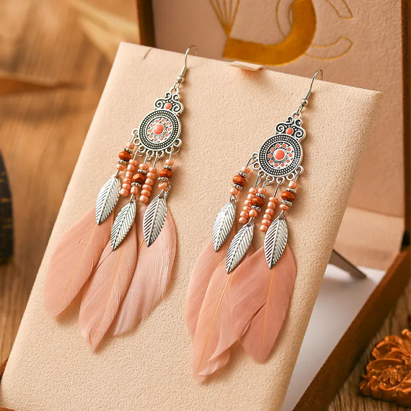 Round drop feather earrings in a bohemian leaf shape with patterned detail, shown in a light pink electroplated colour.