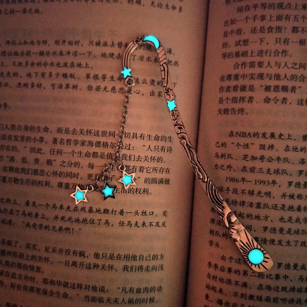 Retro five-pointed star glowing metal bookmark in ancient silver and bronze finishes on an open book.