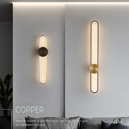 Modern round wall lamp with black iron shade and warm LED light, mounted on a grey wall.