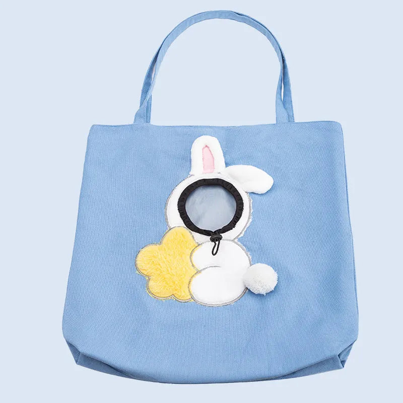 Little Bee Design blue canvas pet carrier bag with animal pattern, showing adjustable side opening for a pet's head.