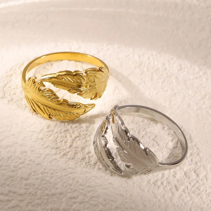 Women's stainless steel feather fashion ring with adjustable opening in silver or gold colour