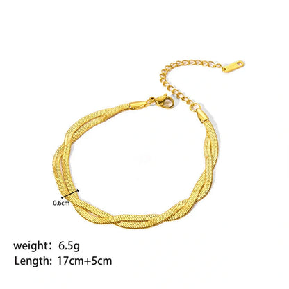 Elegant stainless steel bracelet with a sleek geometric design, gold-plated finish, and unisex style suitable for any occasion.