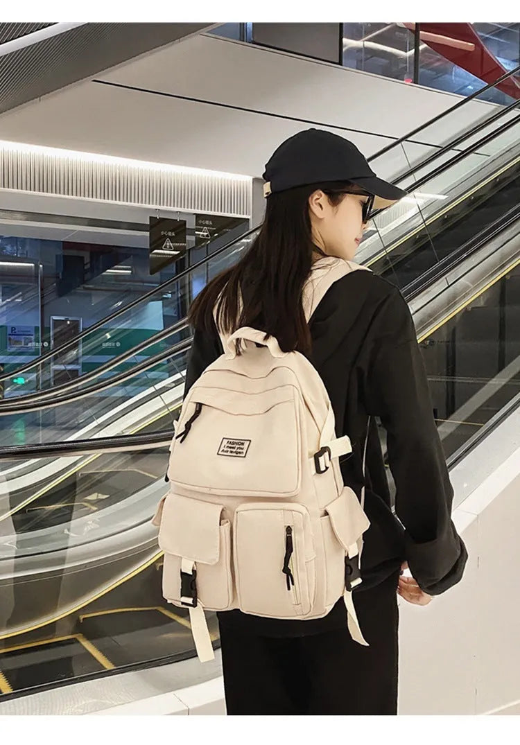 Black and white nylon student backpack with laptop compartment and three-dimensional pocket.