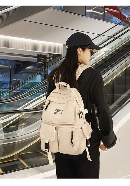 Black and white nylon student backpack with laptop compartment and three-dimensional pocket.