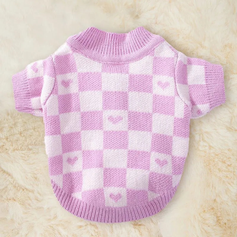 Blue and checkerboard patterned dog coats for small breeds on a white background.