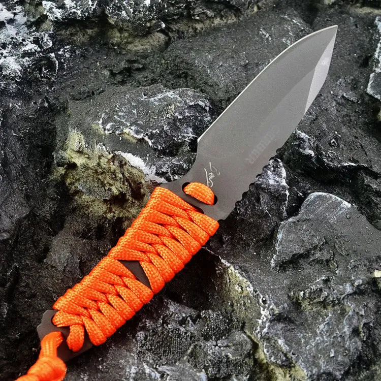 Straight-blade survival knife with a binding rope handle next to its black ABS plastic sheath.