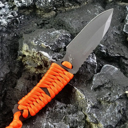 Straight-blade survival knife with a binding rope handle next to its black ABS plastic sheath.
