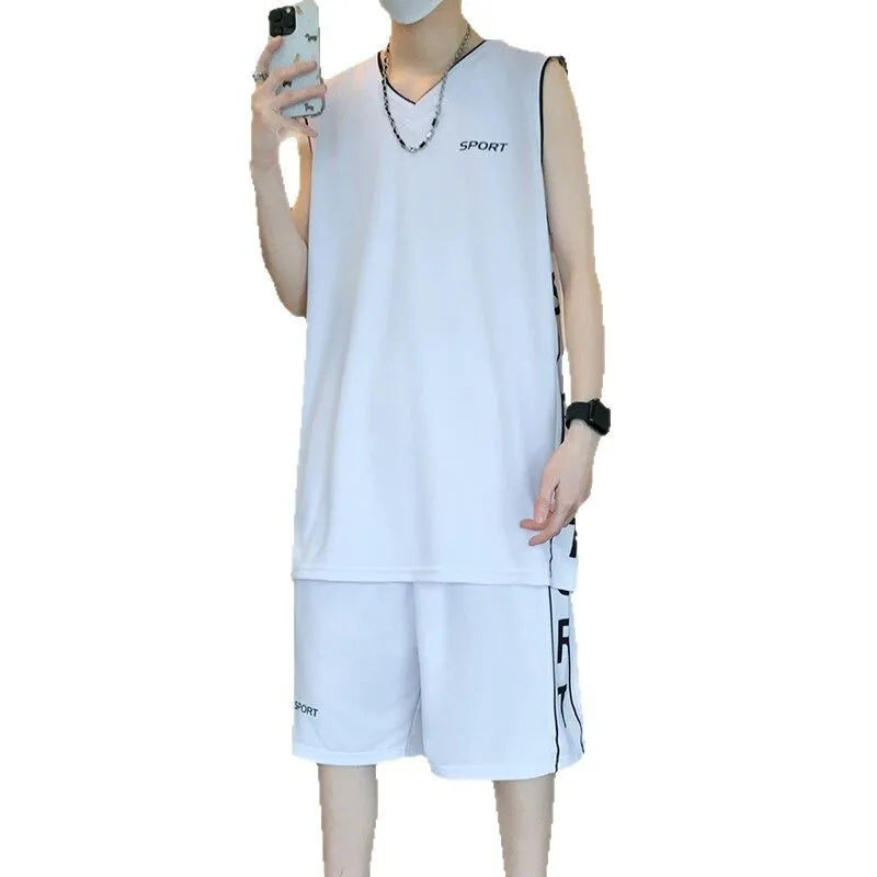 Man wearing a grey sleeveless basketball vest and matching shorts for sports.