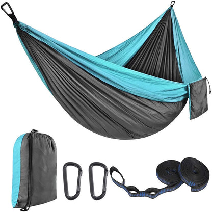 Parachute cloth double camping hammock in chosen colour, with black buckles and round ropes on a tree.