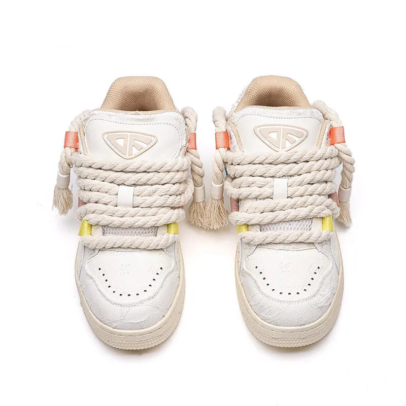 Creamy white old damage lace-up retro skateboard shoes with platform heel on a rubber sole.