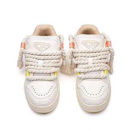 Creamy white old damage lace-up retro skateboard shoes with platform heel on a rubber sole.