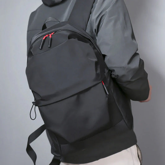 Stylish and durable nylon backpack for everyday use, available in black and light grey.