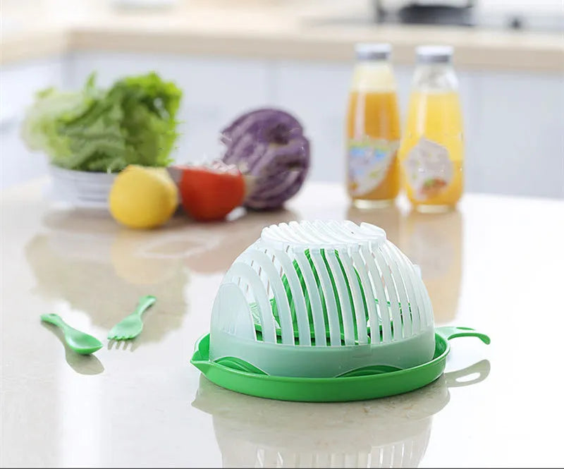 Blue salad cutter bowl showing cutting lid with seams, drain basket function, and reversible base plate