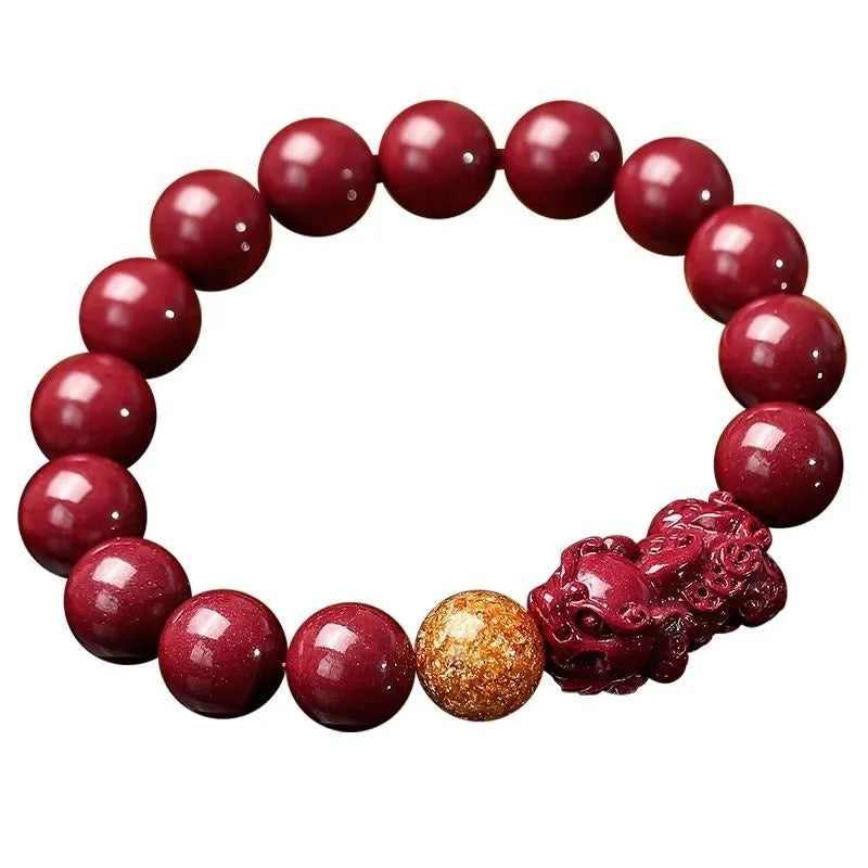 Purple gold sandstone cinnabar bracelet with totem design on a wrist, showing polished beads.
