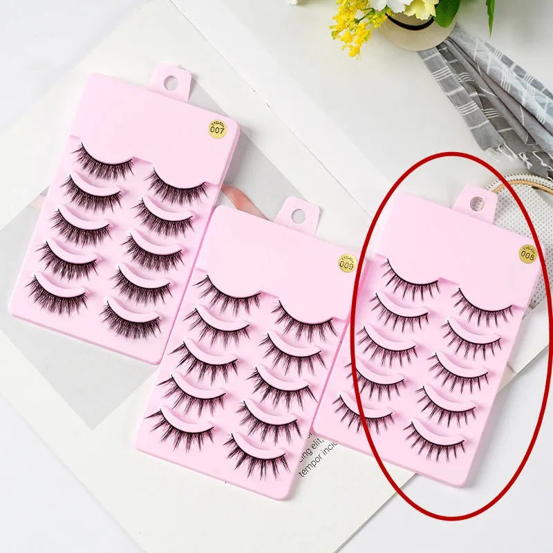 Three styles of black anime false eyelashes on a white background from a 15-pair pack.