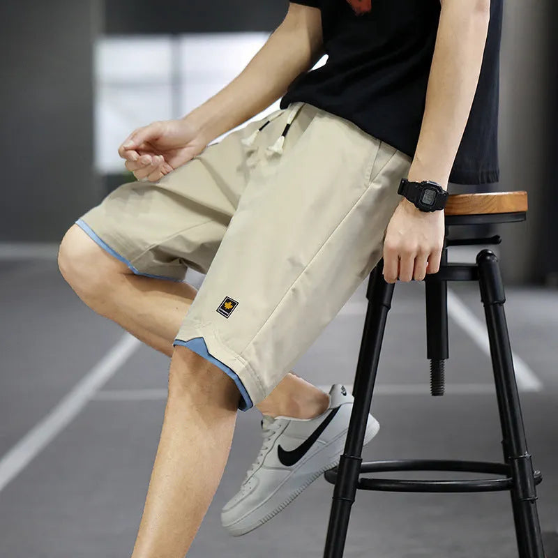 South Korea style loose straight-leg beach shorts in khaki on a plain background