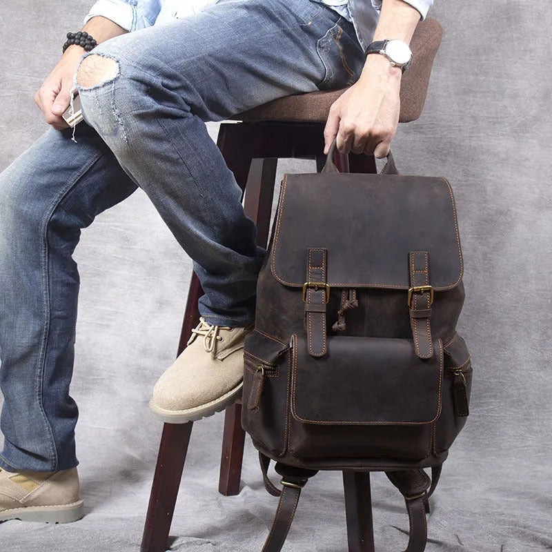 Retro brown genuine cowhide leather backpack with shoulder straps and a top handle.
