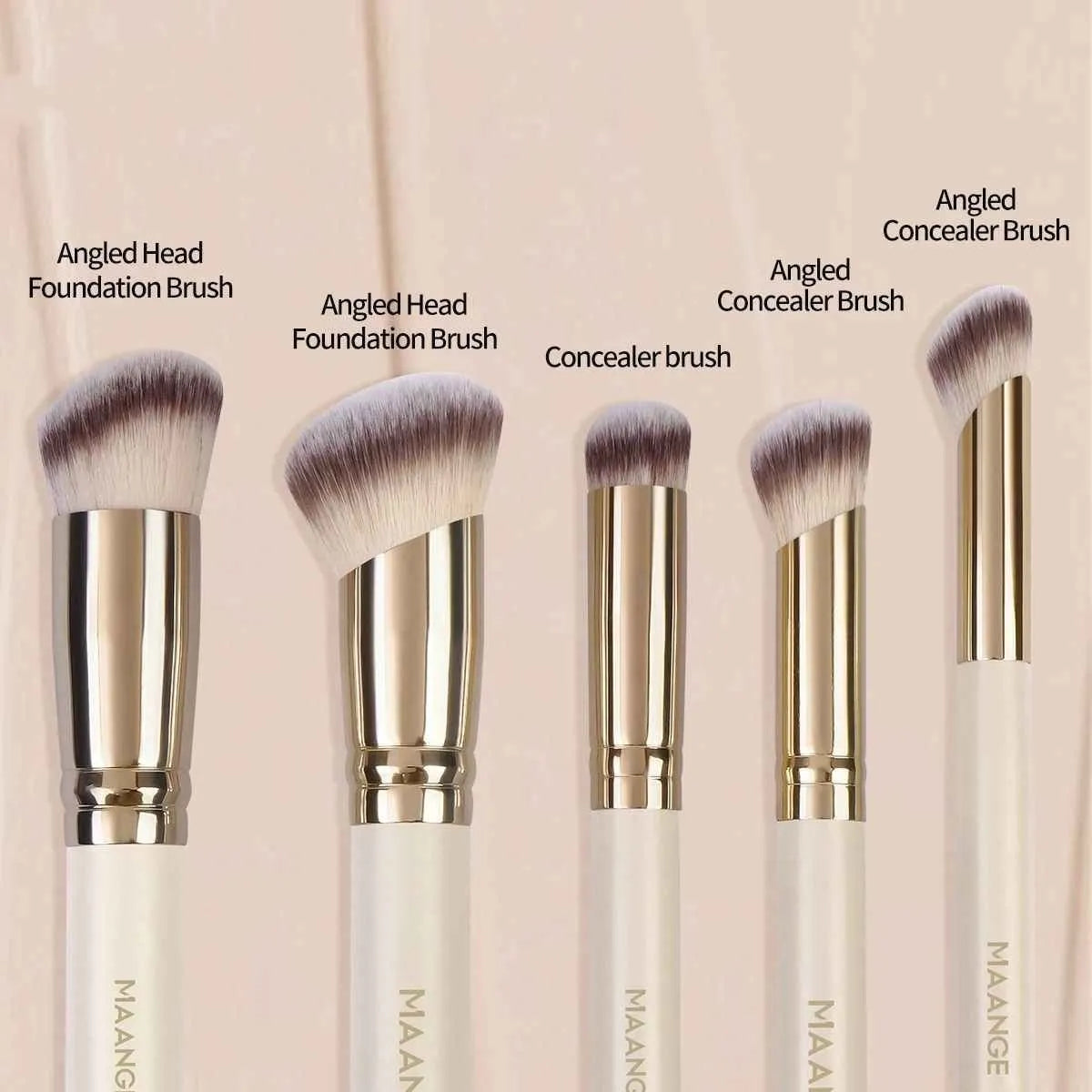 Apricot-coloured angled blush brush and four other synthetic makeup brushes on a white background