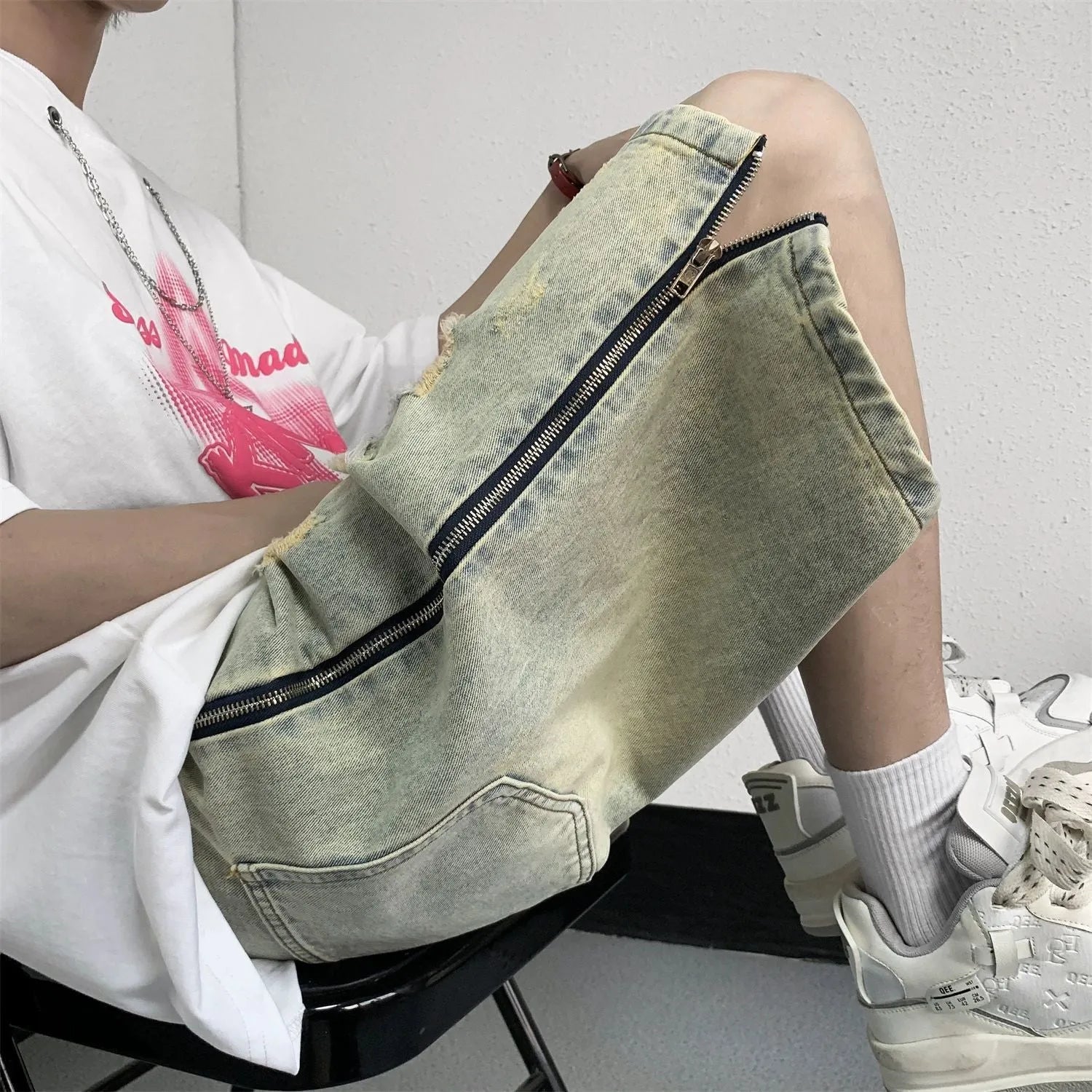 Men's blue denim shorts with retro yellow mud ripped detailing and button-front cardigan closure