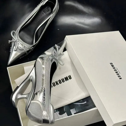 Women's black pointed toe shoes with a distinctive floating Mary Jane heel.