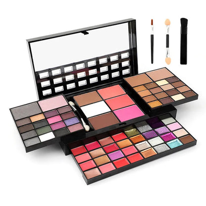 Open 74 colour makeup combination palette showing four layers of eyeshadow, lip gloss, blush and contour powders with brushes.
