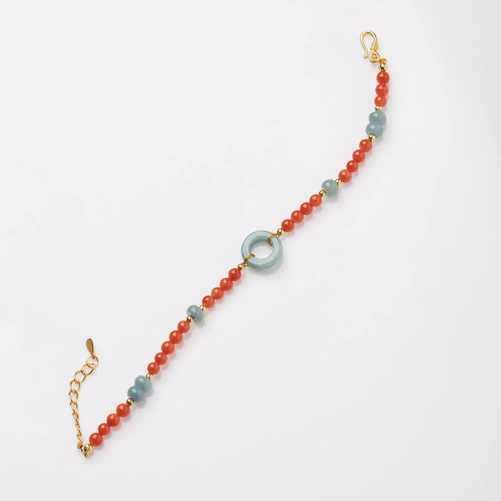 Natural South Red Agate women's bracelet with safety buckle on a wrist, showing geometric beads and auspicious patterns.