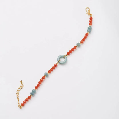 Natural South Red Agate women's bracelet with safety buckle on a wrist, showing geometric beads and auspicious patterns.