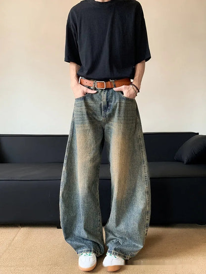 Men's distressed retro blue jeans with a slim wide-leg cut and mid waist.
