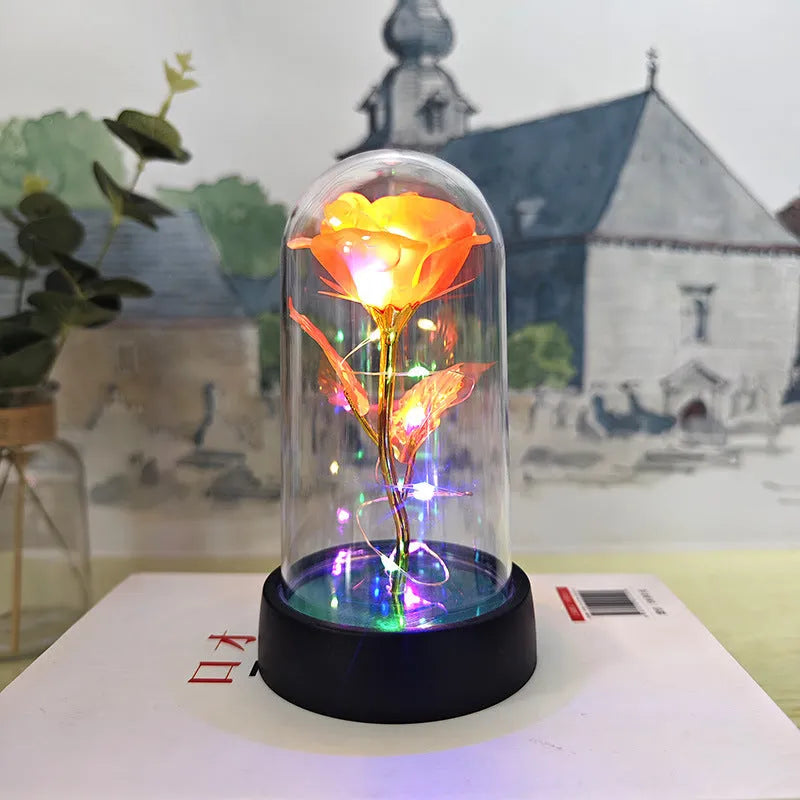 Glass cover small night lamp with plastic flowers, 15cm height, black base, showing colour light options
