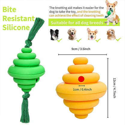 Green and yellow dog ball with attached knotted rope chew and feeder toy on grass.