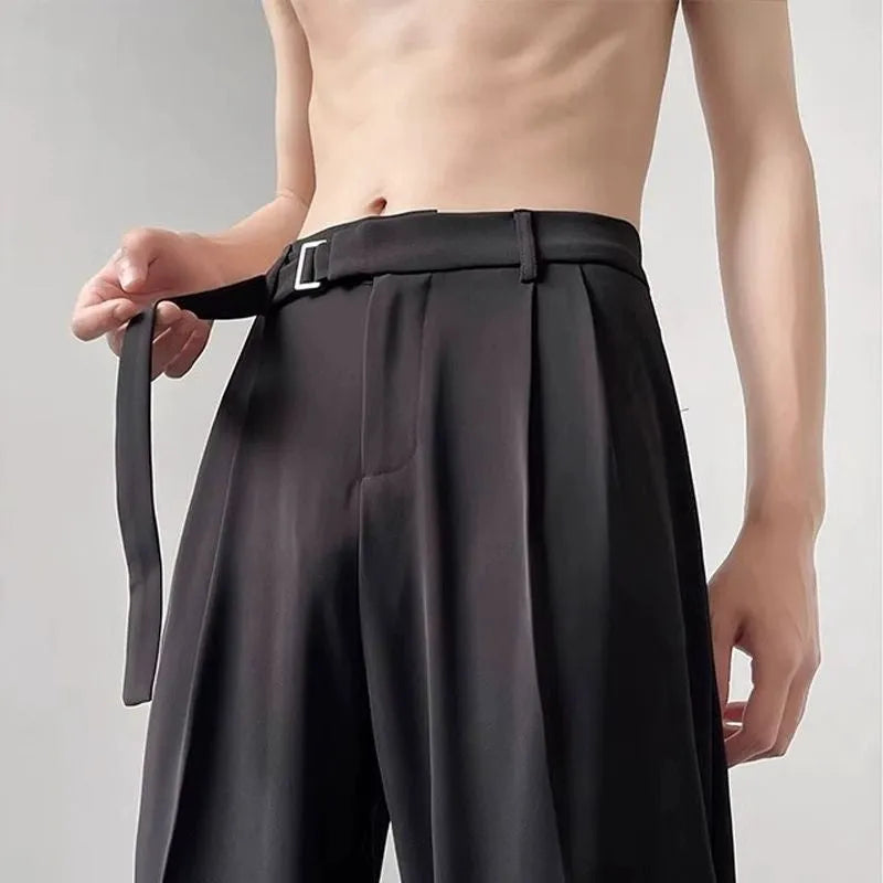 A pair of black straight leg wide fit women's trousers with a loose, casual silhouette on a hanger.