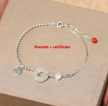 Silver women's bracelet with Hetian jade stones and a geometric peace buckle charm.