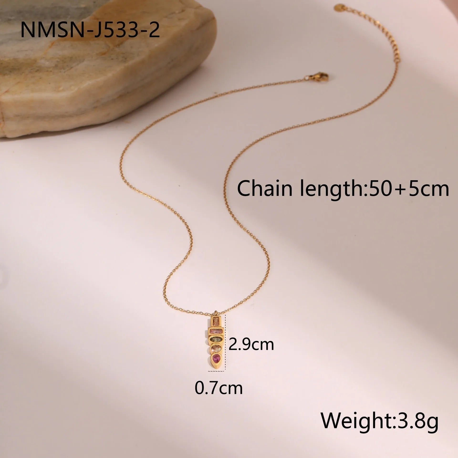 Gold geometric jewellery set with colour zircon accents showing necklace, ring, and earrings
