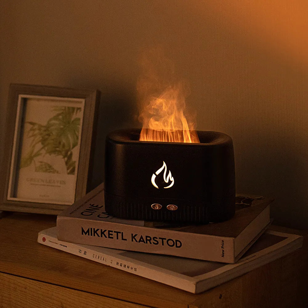 Black simulated flame aromatherapy humidifier with USB cable, water tank, and control buttons on a wooden surface.