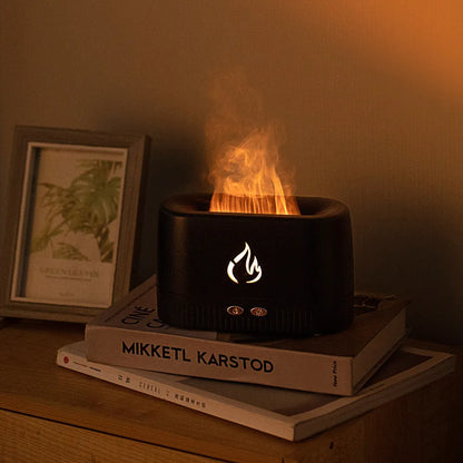 Black simulated flame aromatherapy humidifier with USB cable, water tank, and control buttons on a wooden surface.