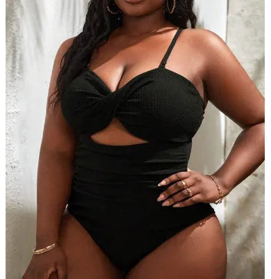 Black plus size one-piece swimsuit for women on a hanger.